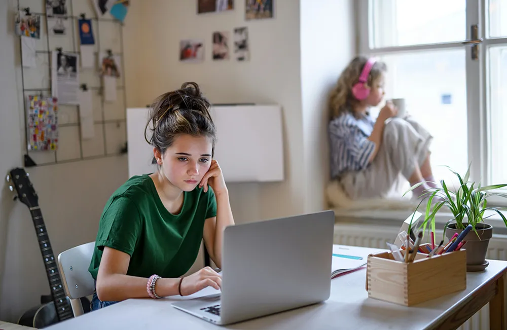 AA student, sitting and working on a computer.